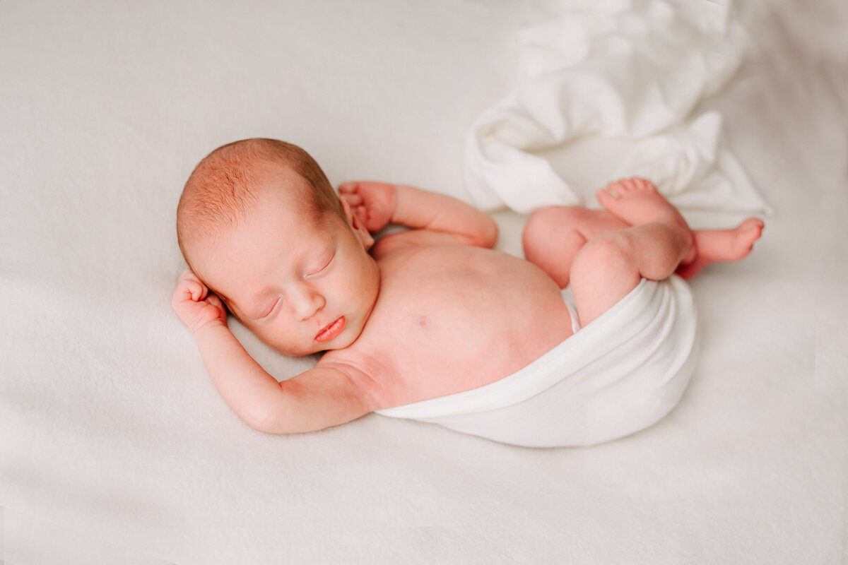 baby boy resting in a casual swaddle in Guelph Newborn session.