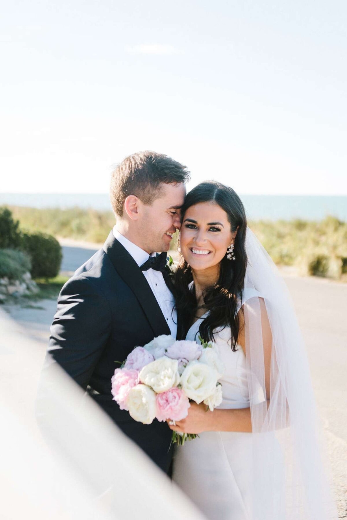 Classic and Elegant  Wedding Portrait along the Beach with a Peony Bouquet for a Luxury Michigan Lakefront Golf Club Wedding.