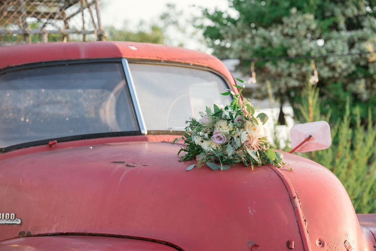 photo of bouquet on red car from wedding at The Loft by Bridgeview