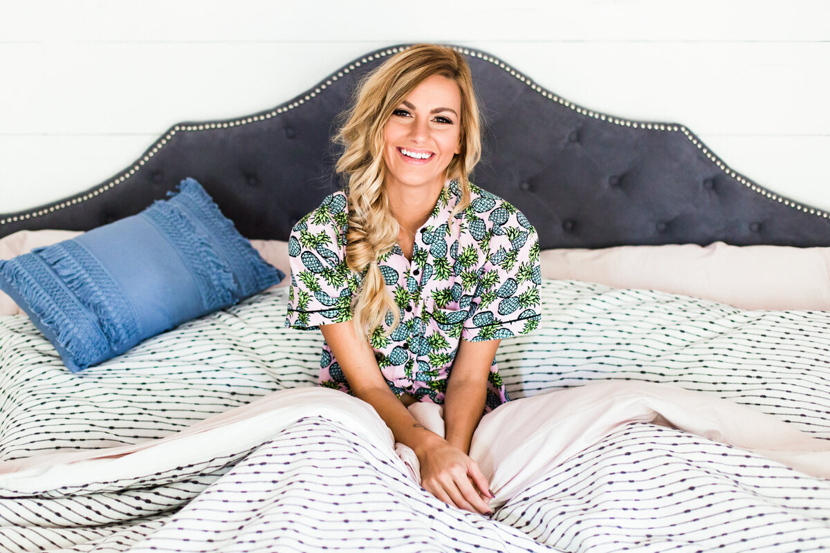 lifestyle portrait of woman in pajamas in bed