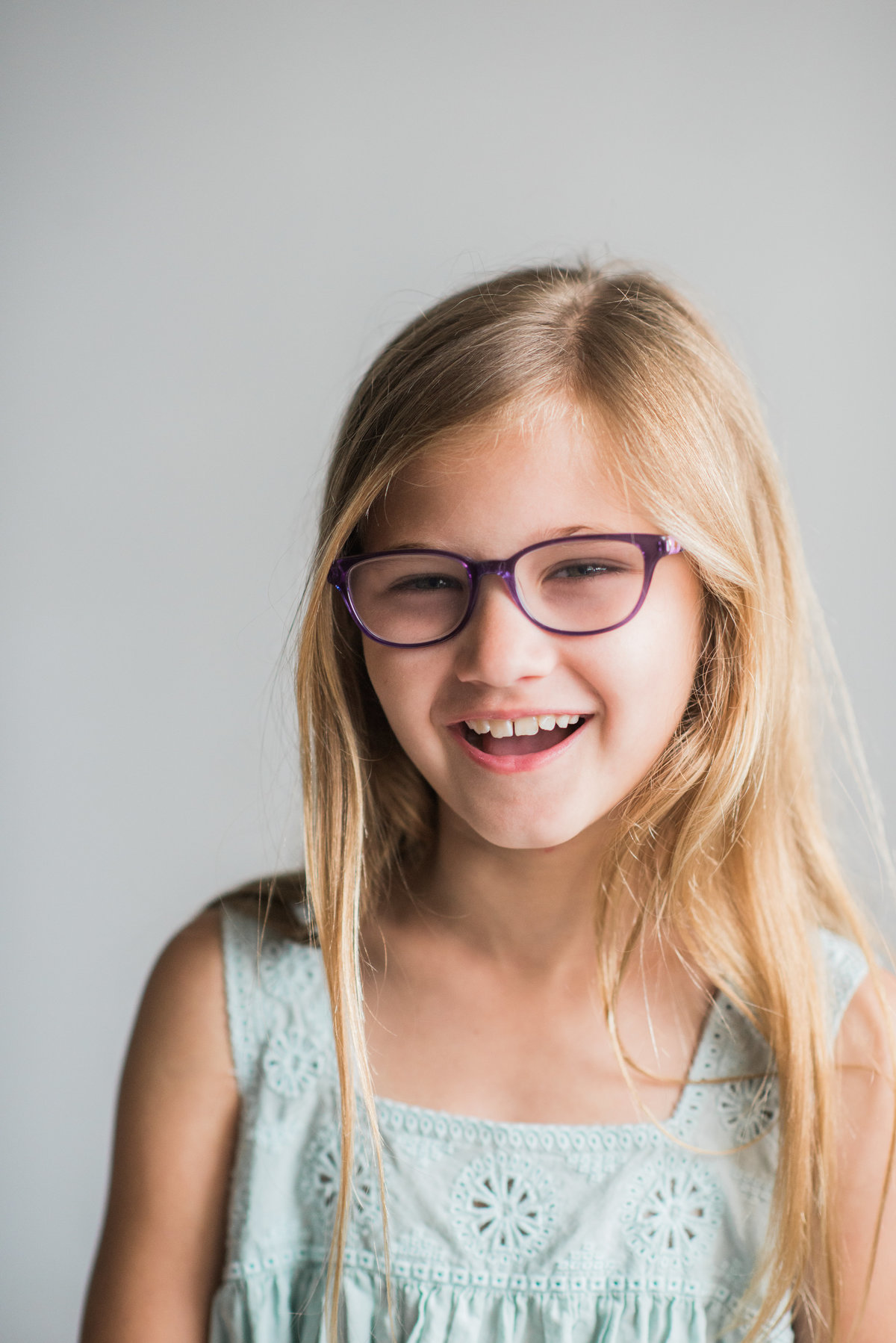 blonde girl laughing with glasses