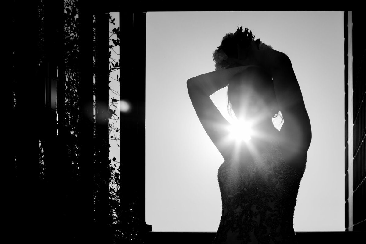 An artistic bridal shot into the sun and silhouette of the bride in Mobile, Alabama.