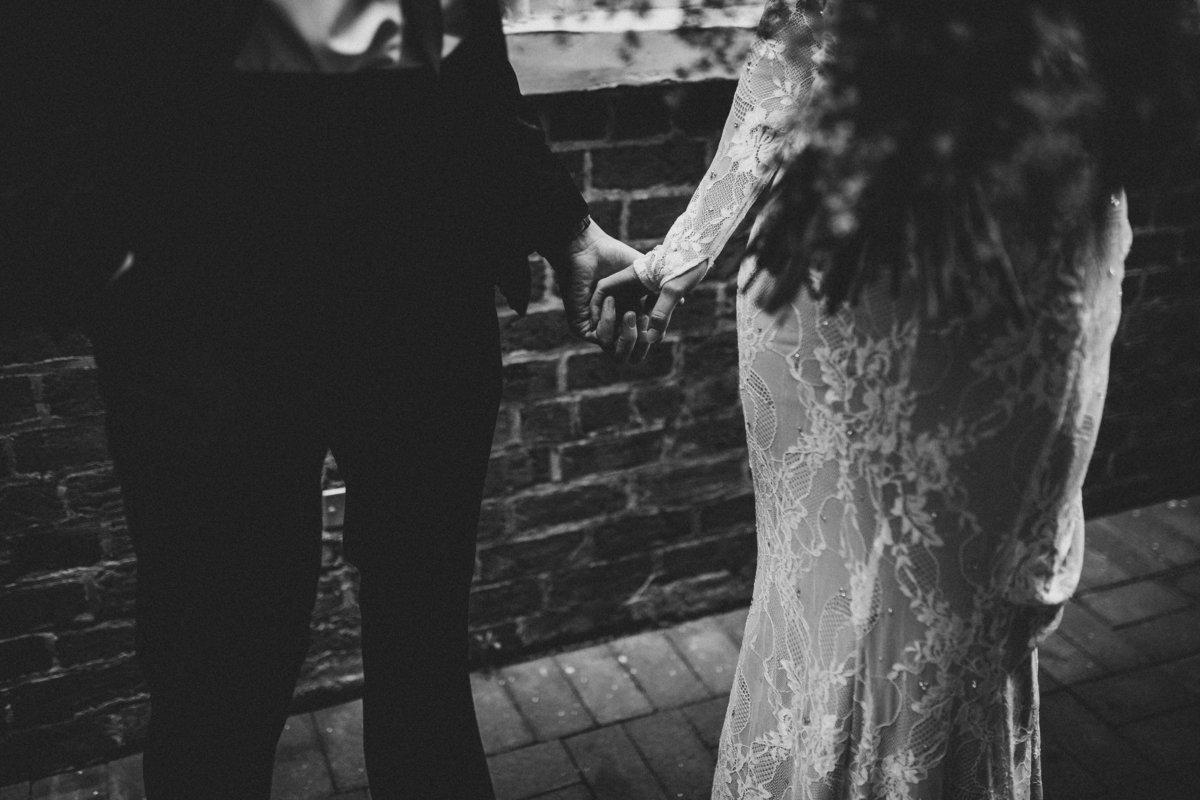 lace-wedding-dress-holding-hands