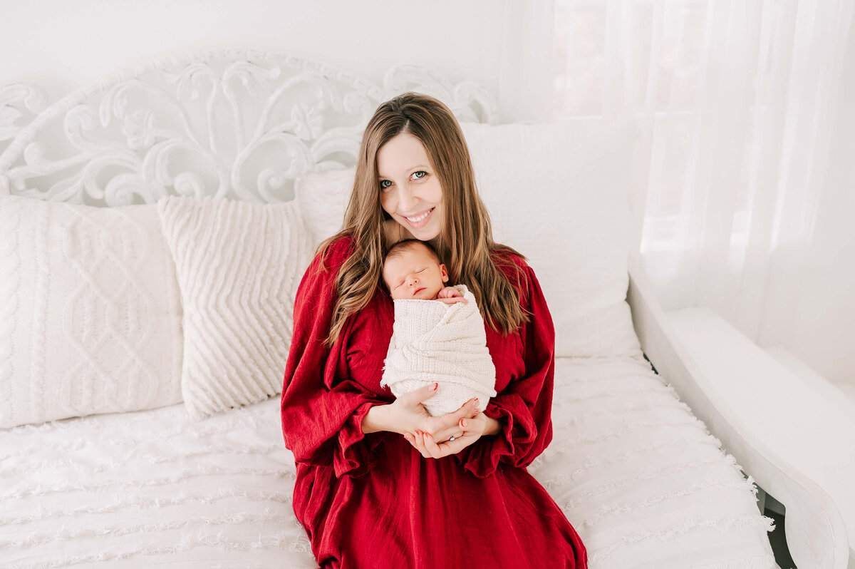 Springfield Mo newborn photographer Jessica Kennedy of The Xo Photography captures mom smiling holding newborn baby boy