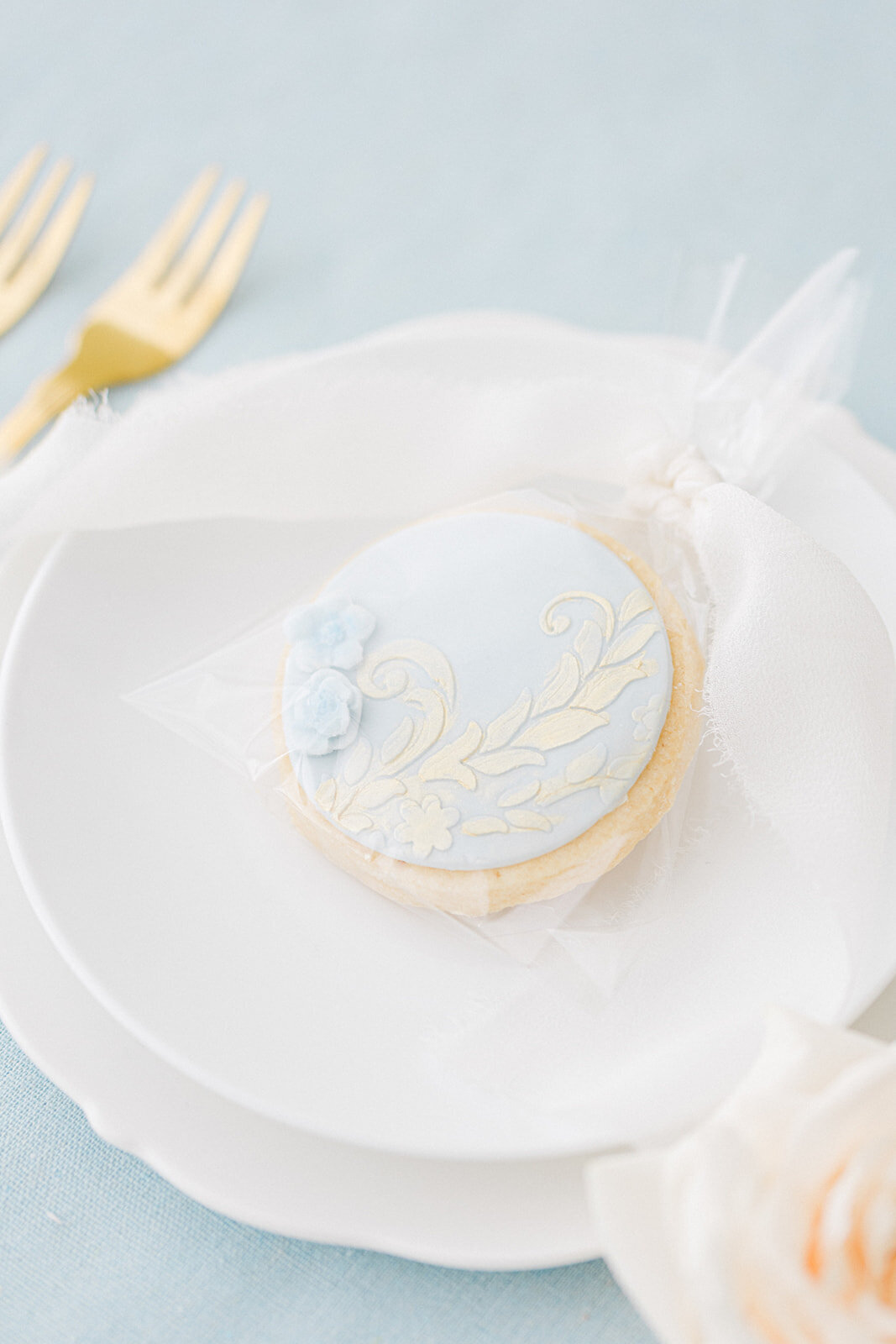 Pale blue Bridgerton inspired wedding favour biscuits
