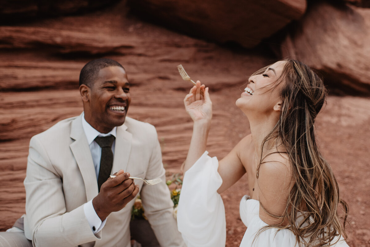 Utah Elopement Photographer captures couple laughing after cake