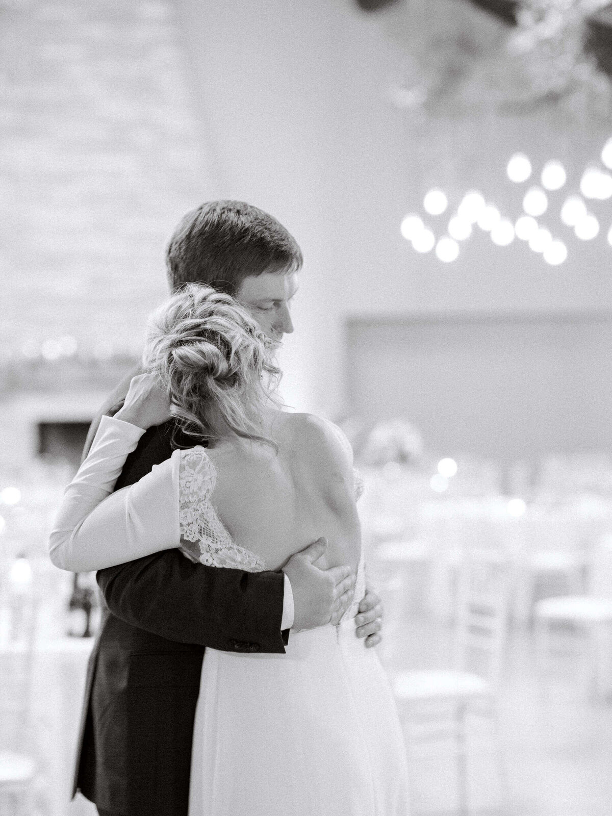 Black and white photo of bride and groom dancing at wedding reception in Canyonwood Ridge