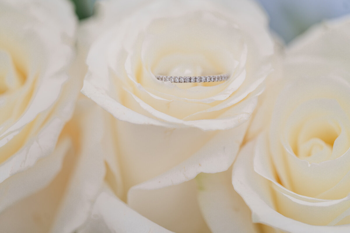 White roses and a wedding band by JoLynn Photography, a North Carolina wedding photographer