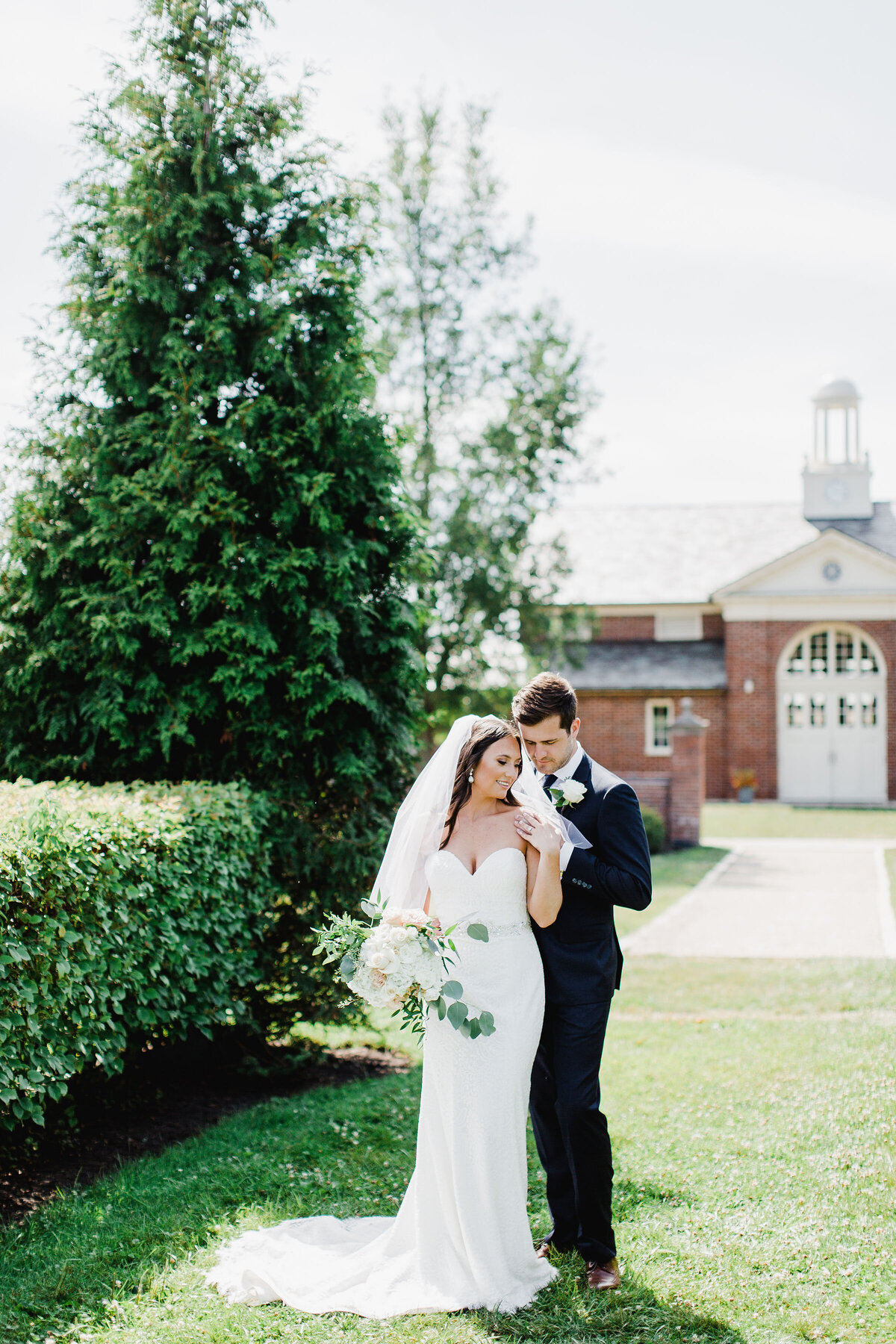 Bride and groom in a romantic embrace at Elawa Farm, surrounded by natural beauty and rustic charm, capturing their love and the venue's serenity