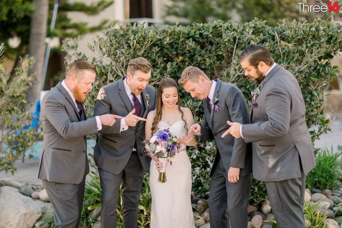 Groomsmen admiring Bride's wedding ring