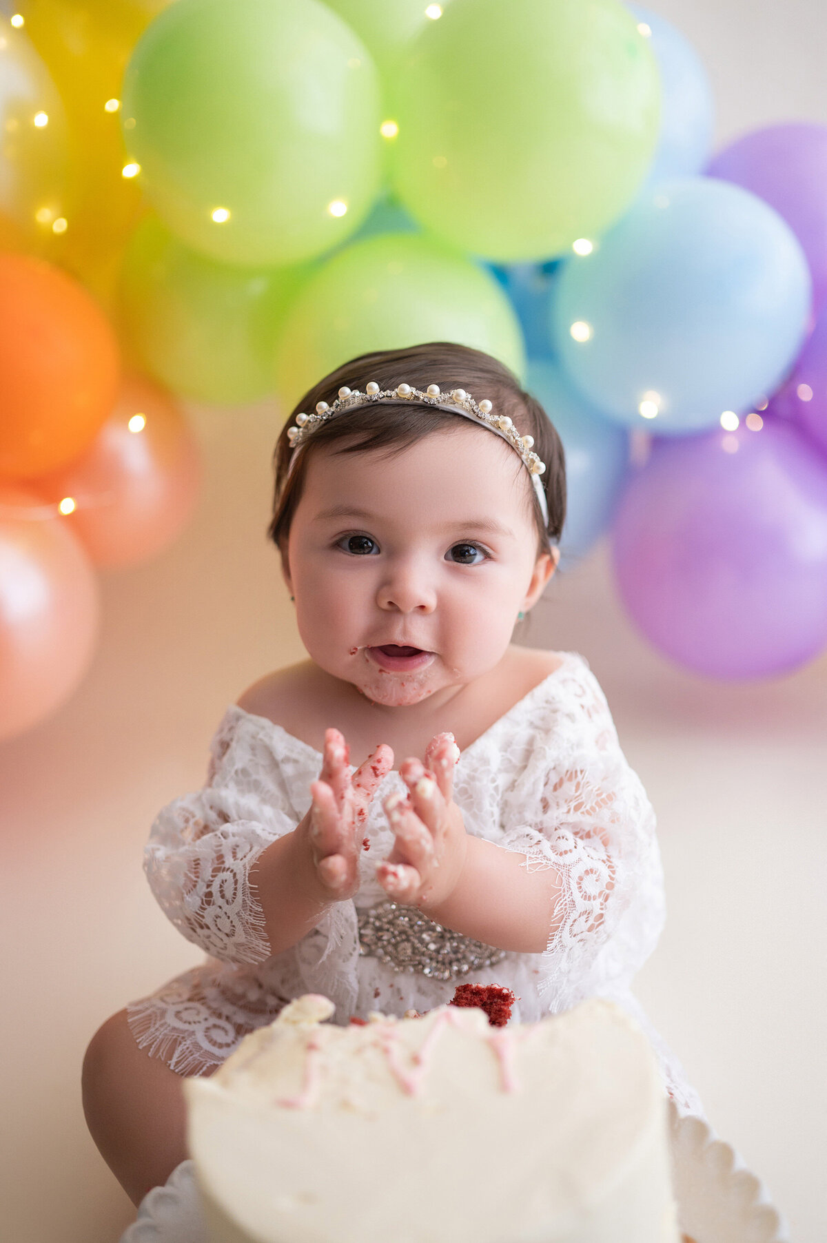 Baby girl has a rainbow-themed cake smash for her first birthday in our Waukesha portrait studio.