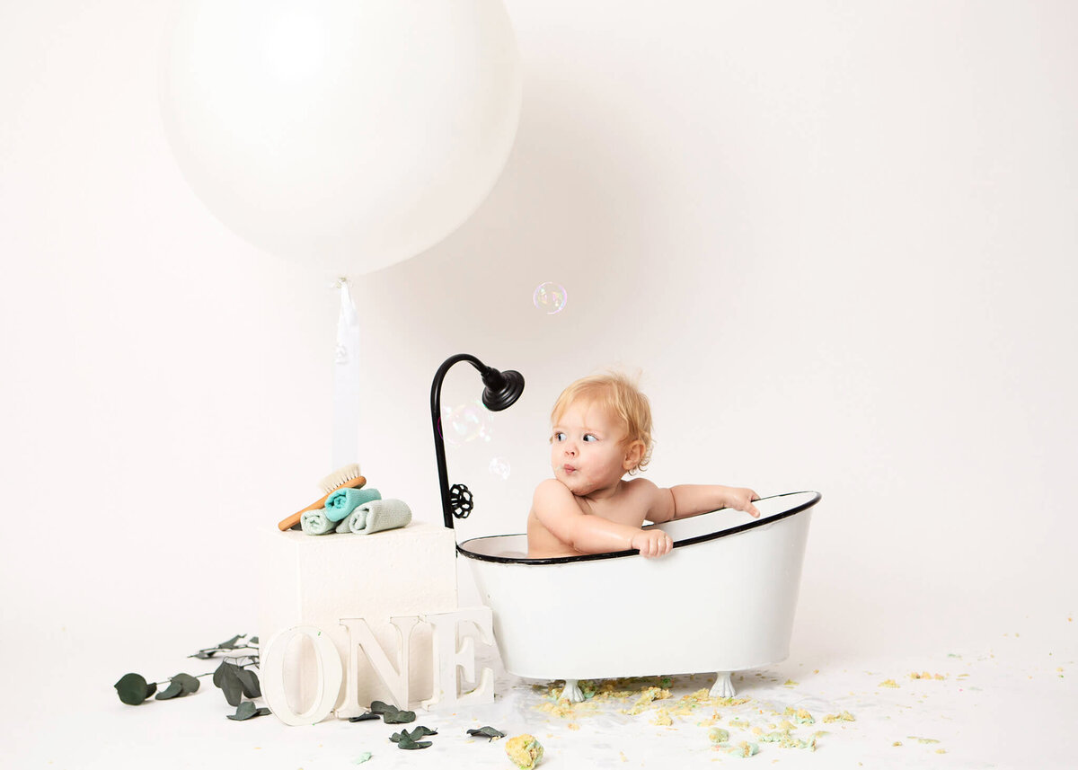 All white cake smash photoshoot, baby sitting in a bath tub photographed in woodland hills - - Los Angeles Newborn Photographer