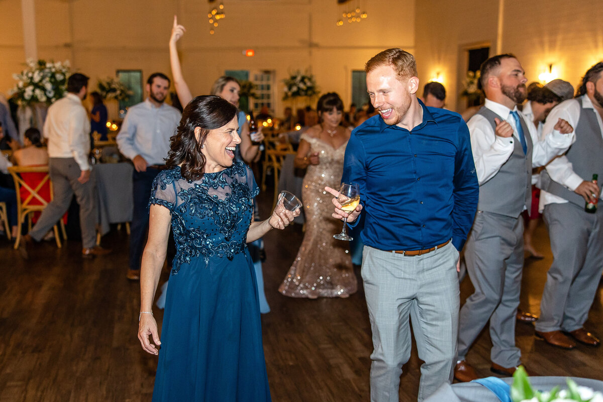 Fort Worth wedding photographer captures guests celebrating at wedding reception guests glasses in hand
