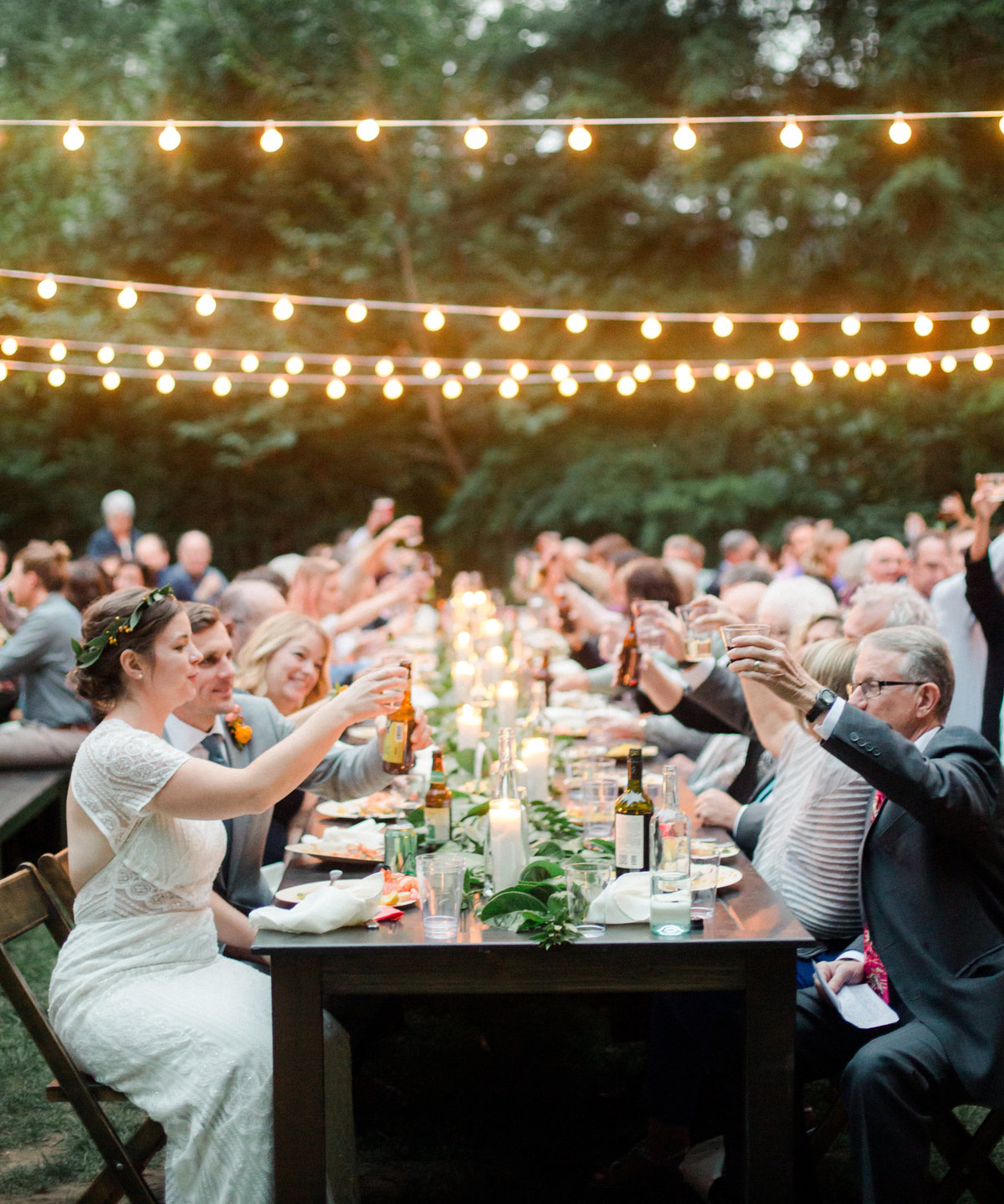 wedding guests cheers over reception table at wellspring spa wedding