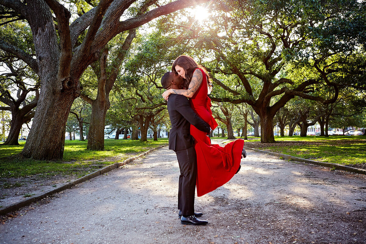 Groom lifting bride at White point Garden, The Battery Charleston Wedding Photographer