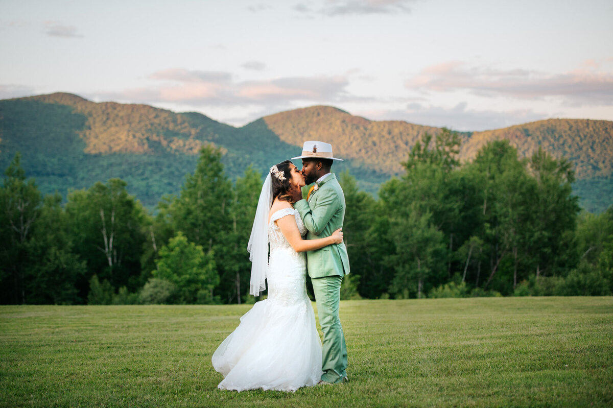 stylish couple kissing in green mountains vermont chittenden mountain top inn wedding