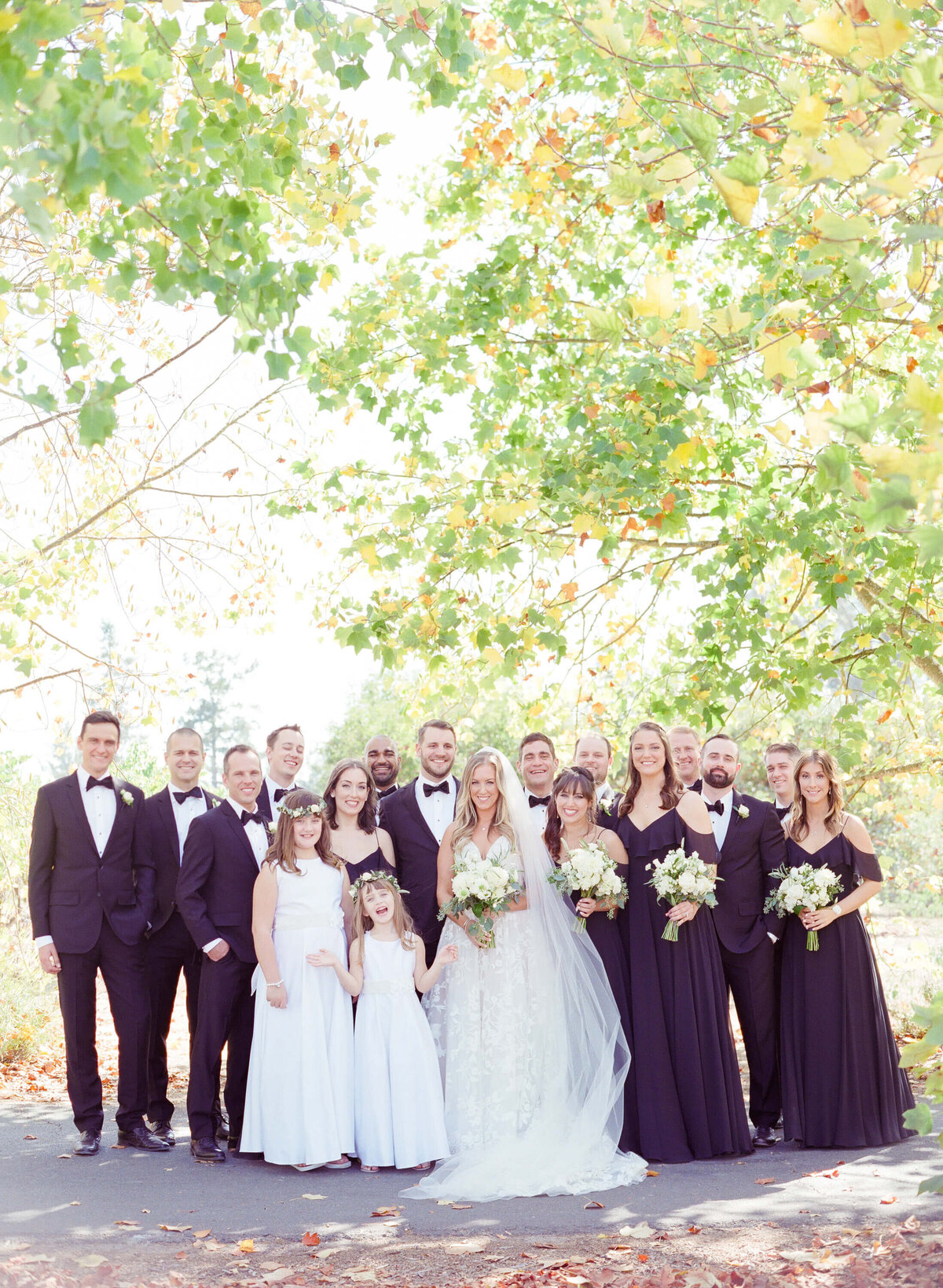 Finally, the groom, his best men, the bride, and her family come together to pose for wedding photographer Robin Jolin at a beautiful vineyard with pleasant light.