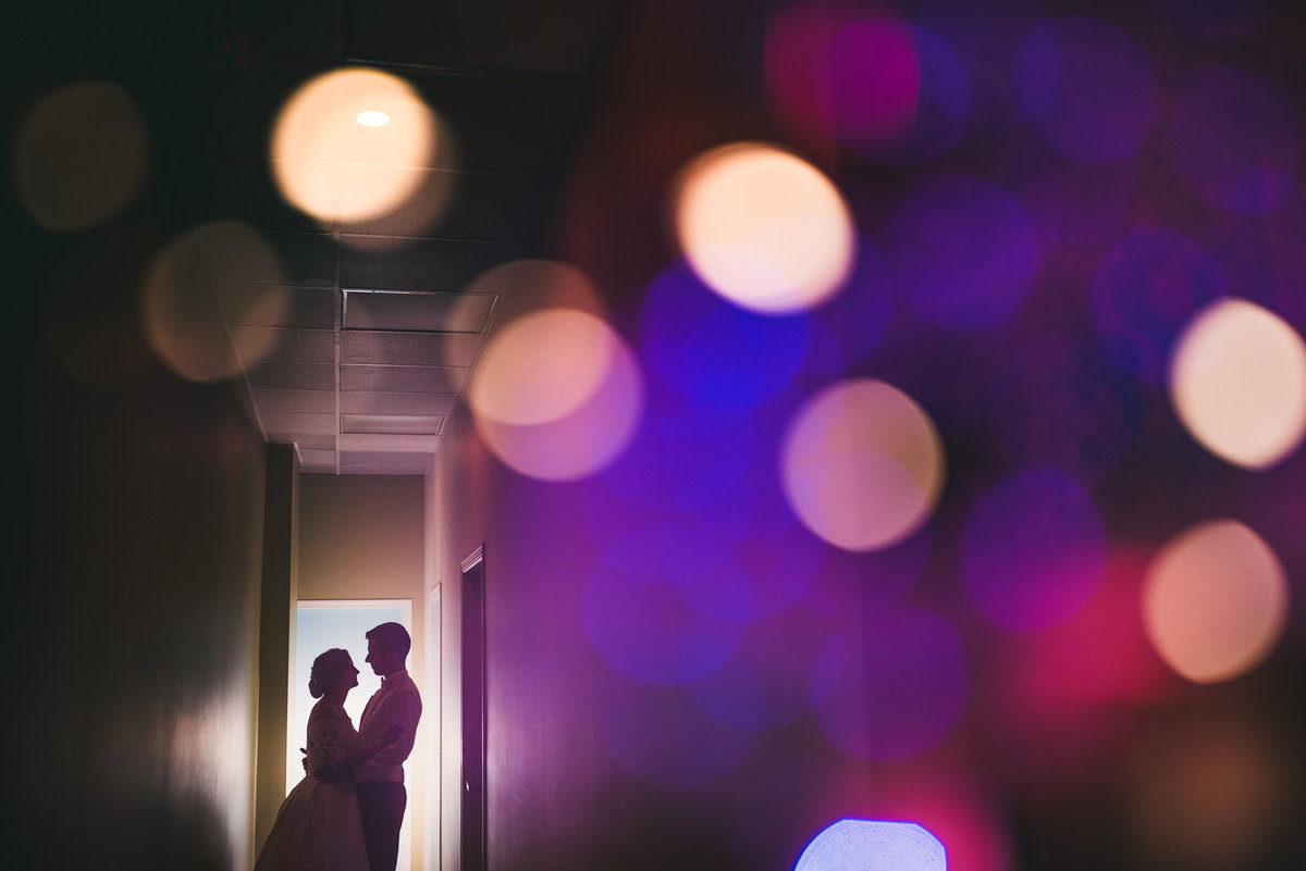 Couple in door way with bokeh lights