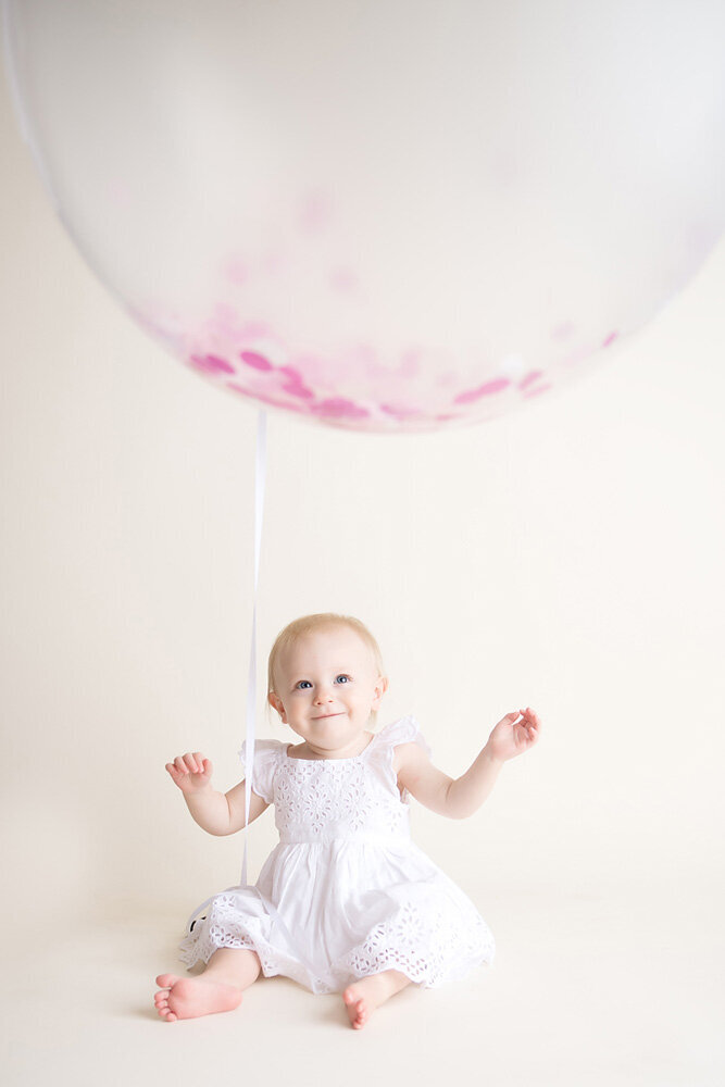 Family session of little girl sitting on the floor