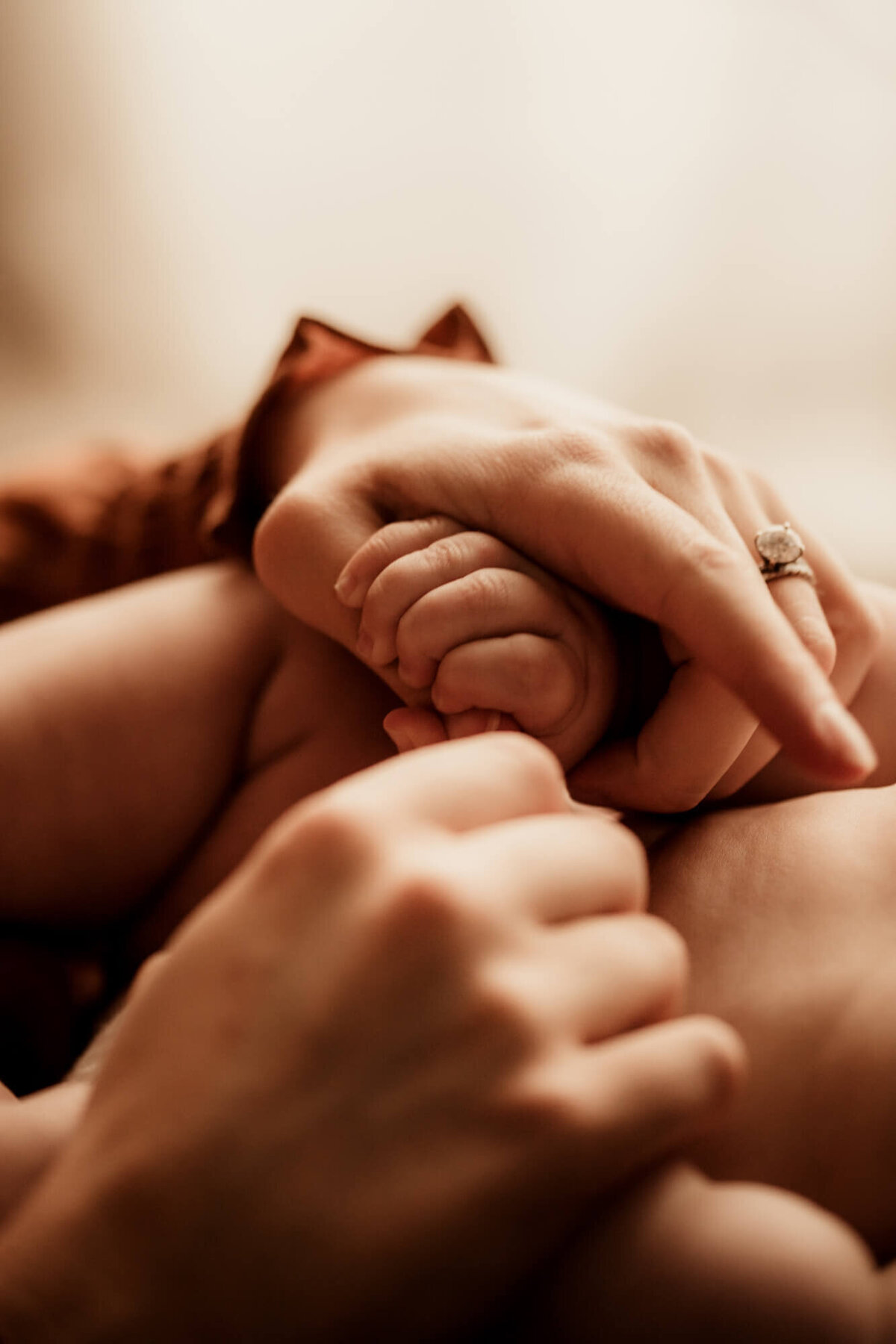 Mother holds her son's hand in her own.