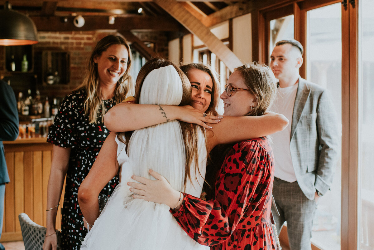 bride hugging her girlfriends