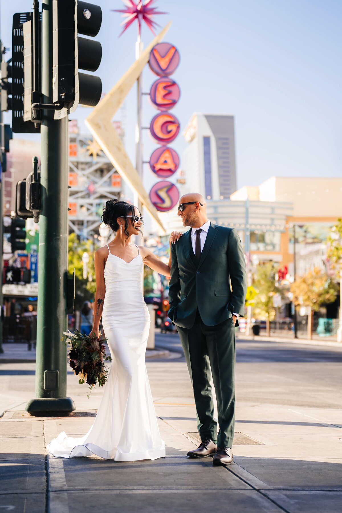 Couple strolling at Fremont street in Las Vegas for their elopement photos. Captured by the best elopement photographer in Las Vegas. John Bognot Photography.