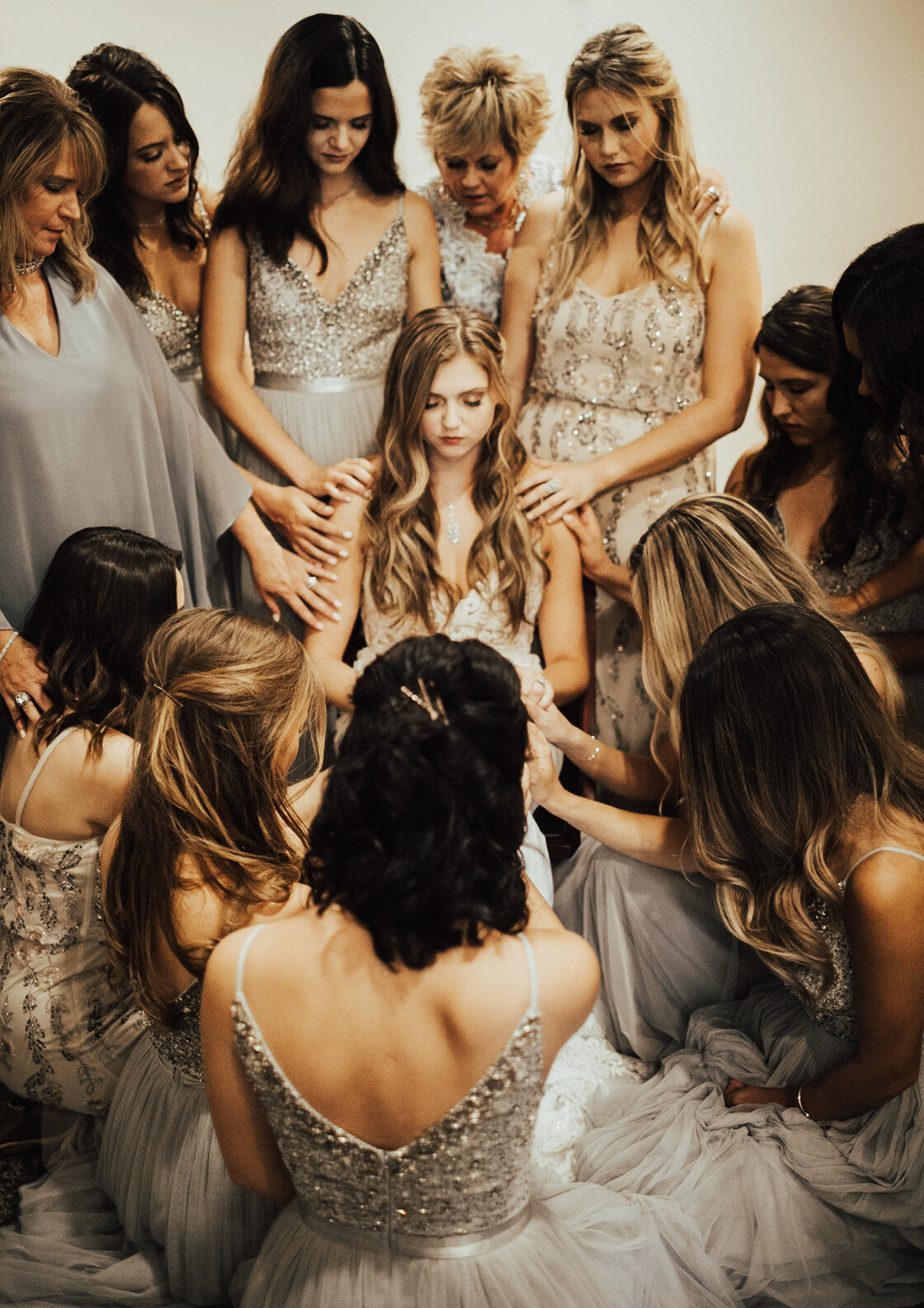 bridesmaids praying for bride before ceremony