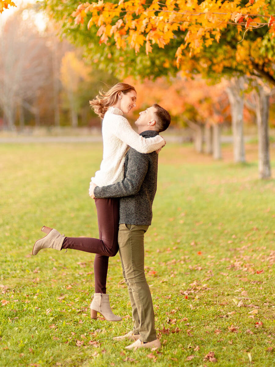 man-lifts-woman-engagement-session