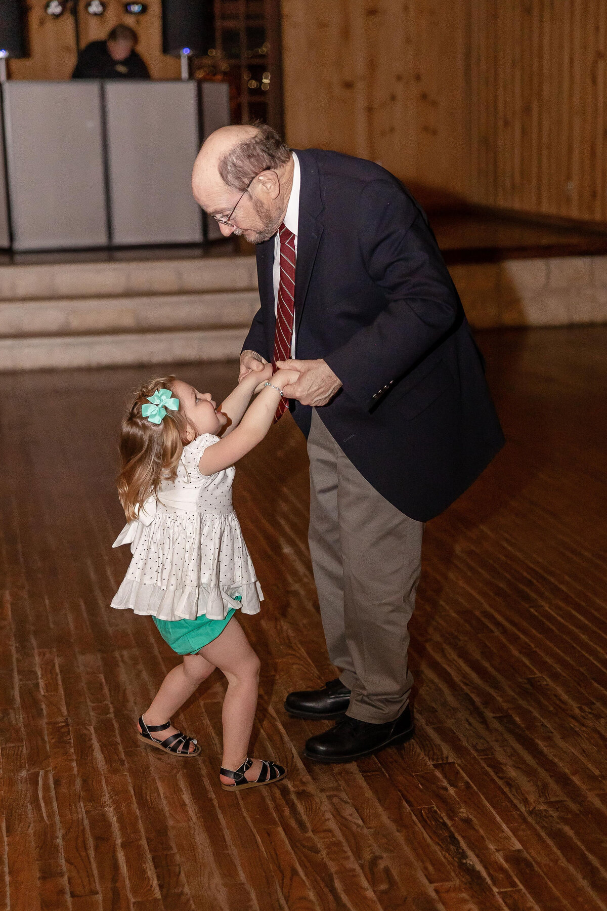 grandfather dances with toddler at wedding reception  in Boerne Texas