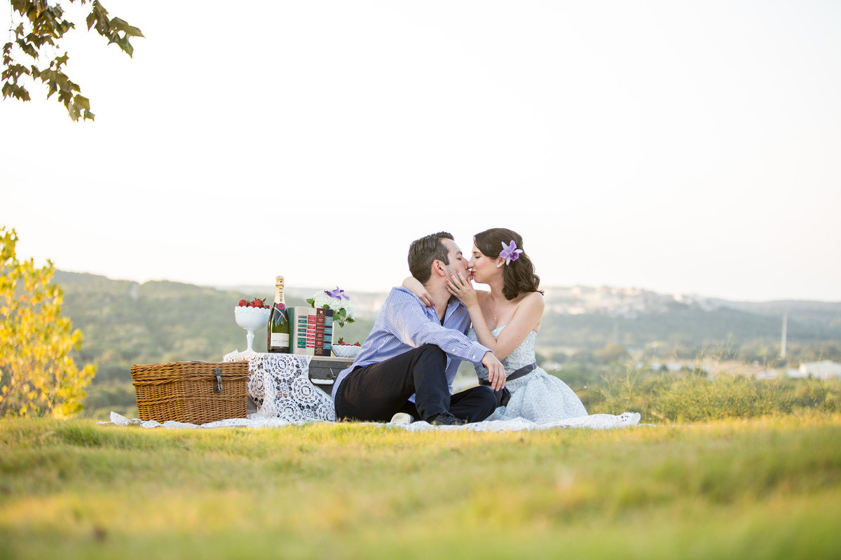 Engagement photography session for couple having a picnic overlooking the Texas Hill Country.