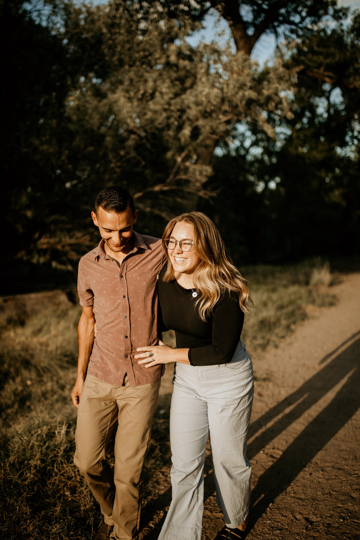 engaged couple walking together in the Bosque in Albuquerque