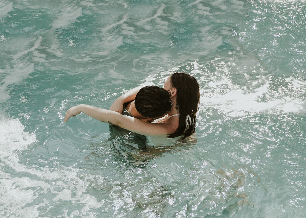 Couple hugging in a pool