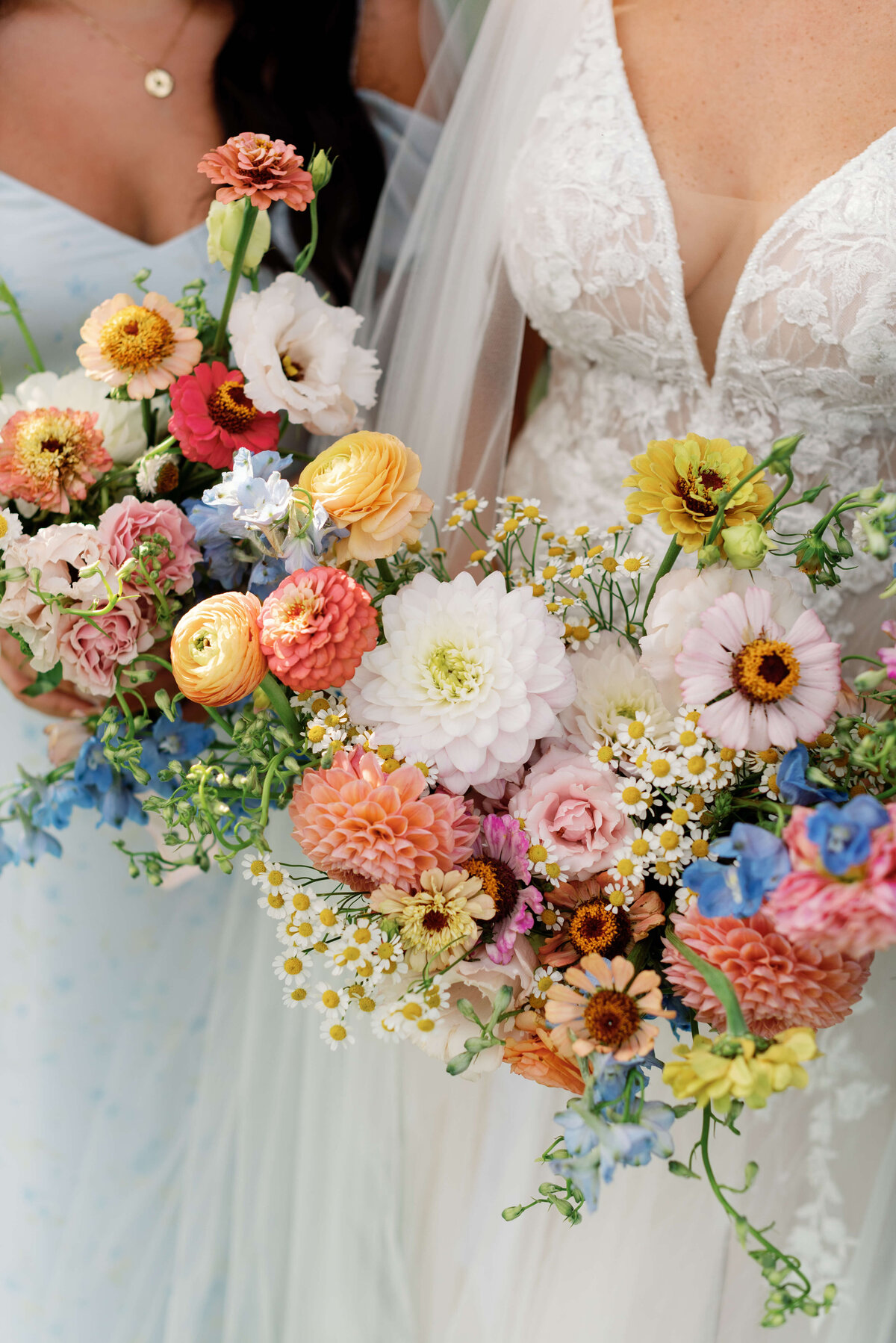 Bride holding colorful florals of pinks, blues, ivory and yellows at Oak Island Resort wedding, Nova Scotia
