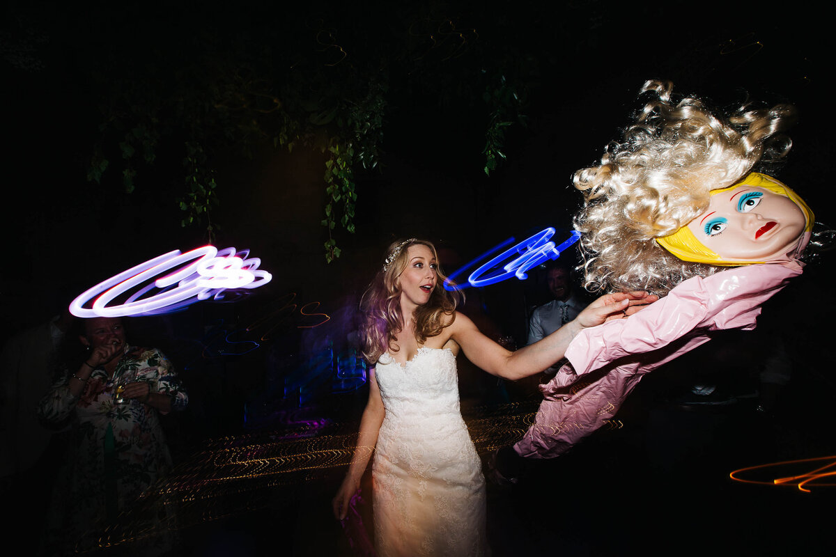Bride throwing a deflated blow up doll across the dance floor at Cripps Barn