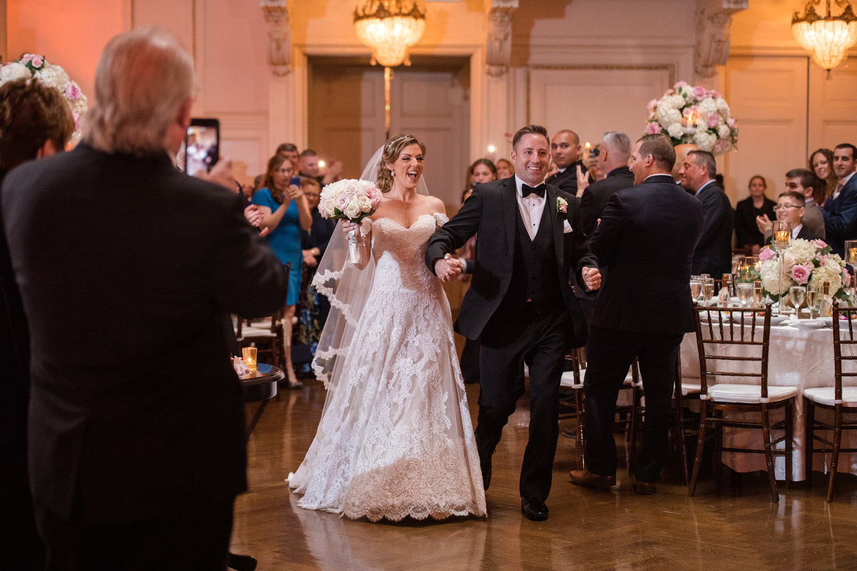 Bride and groom entering the ballroom at The Bourne Mansion