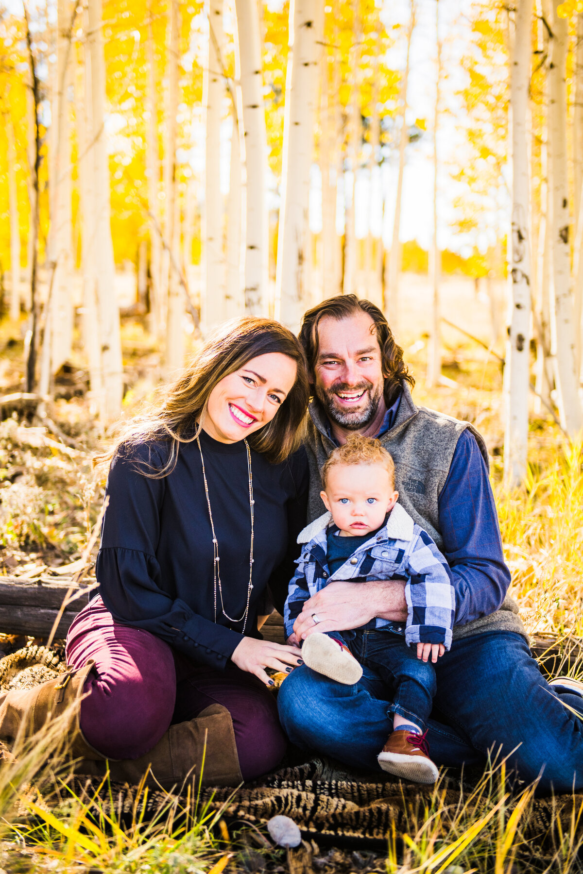 Family in aspens fall autumn leaves yellow smiling at camera Flagstaff photography