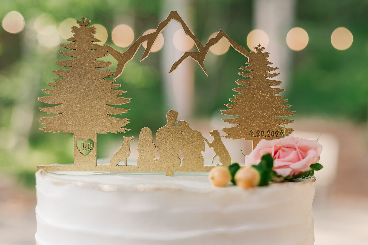 Wilmington wedding photography of a glowing wedding cake topper of a couple and their dog next to flowers
