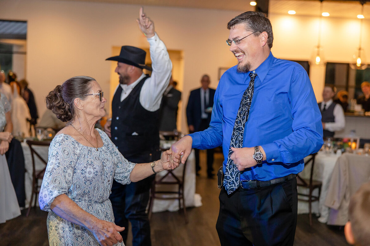 guests of all ages dance at wedding reception