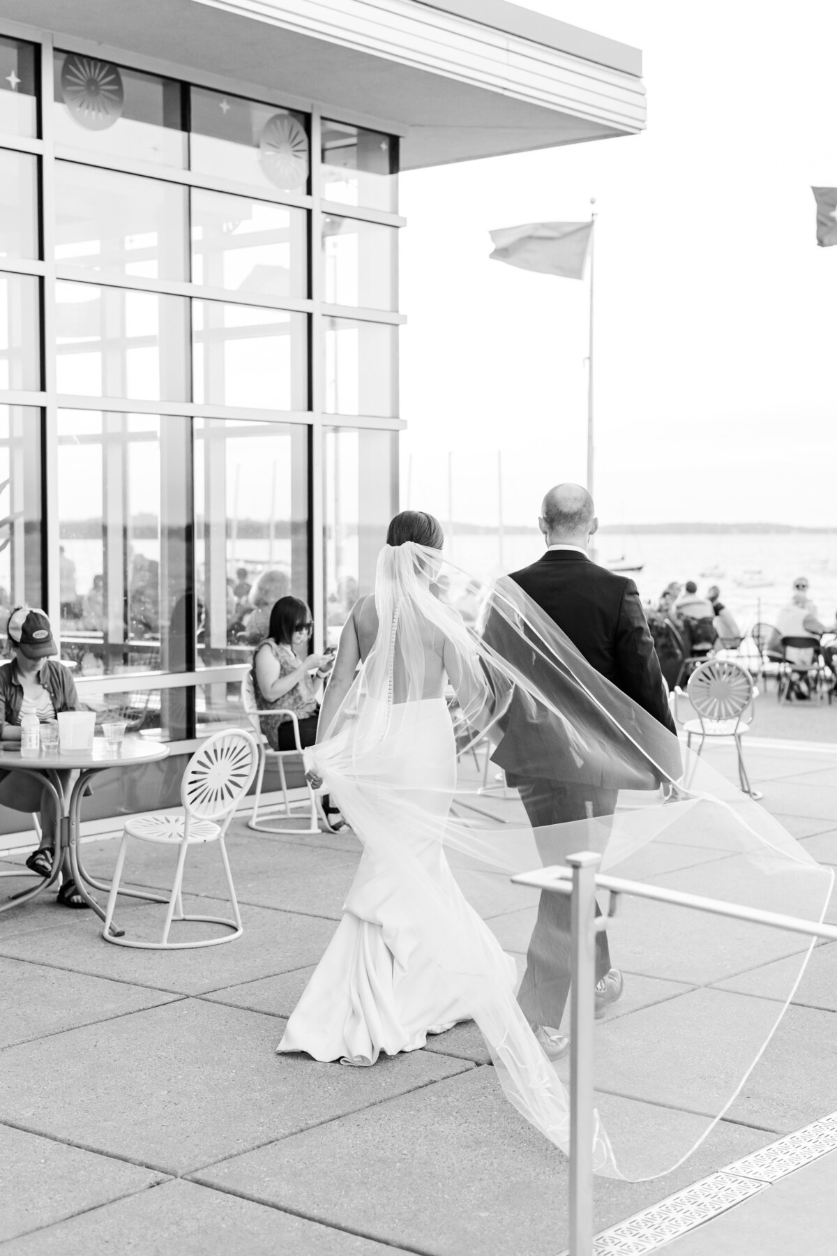 12_bride_and_groom_walking_away_at_sunset_black_and_white
