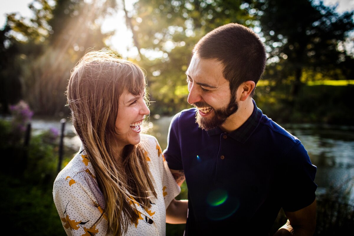 A couple laughs together during a Lincoln Park engagement session.