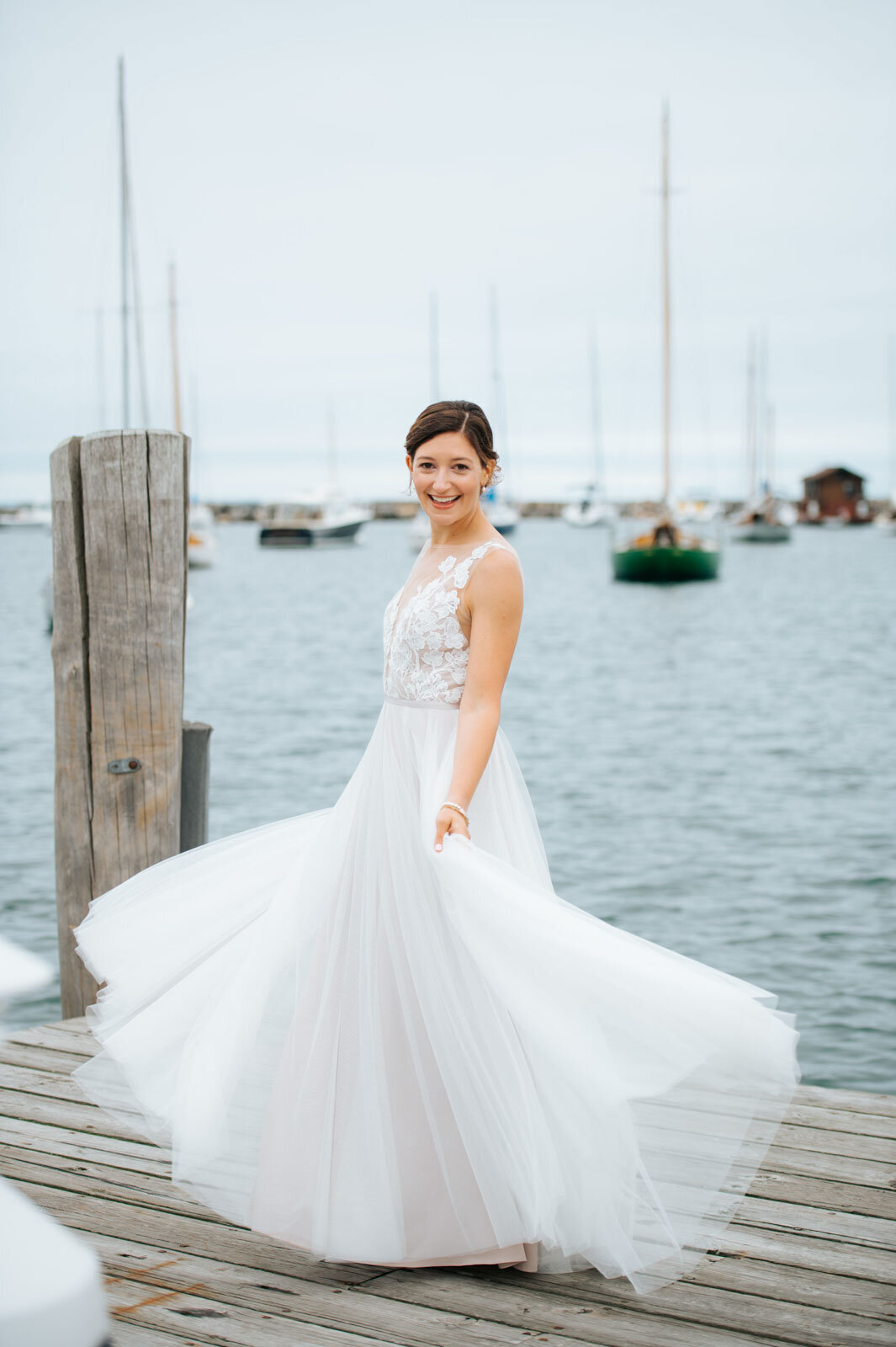 bride twirling dress on a dock at martha's vineyard beach wedding