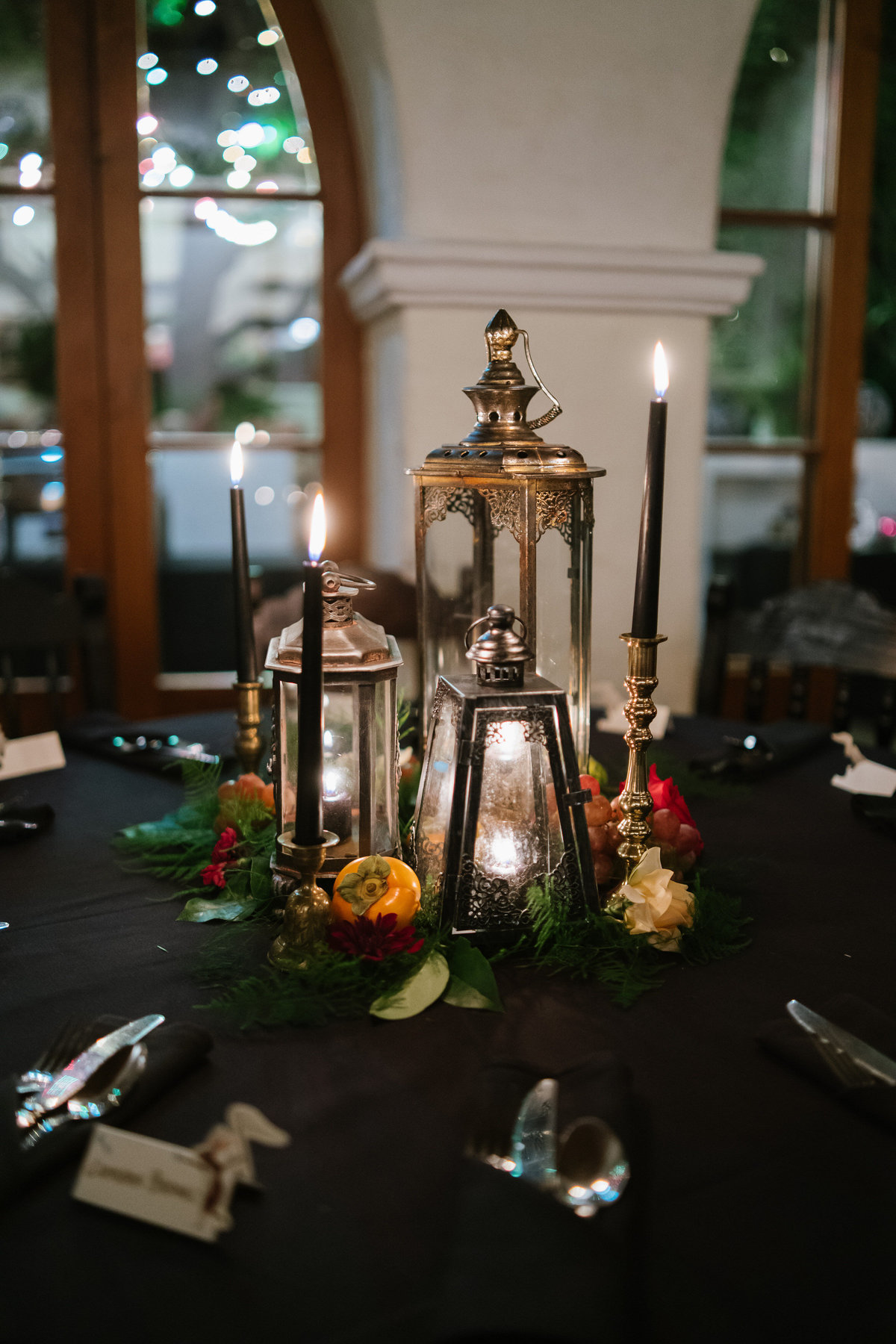 wedding reception table top details brass lanterns with candles and fruit for wedding decor at recption La Fonda on Main