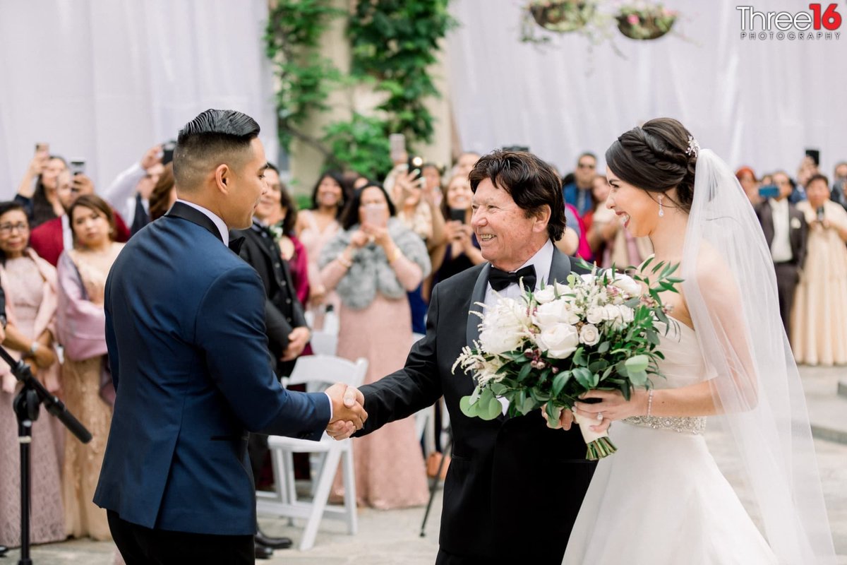 Father of the Bride gives his daughter's hand to the groom