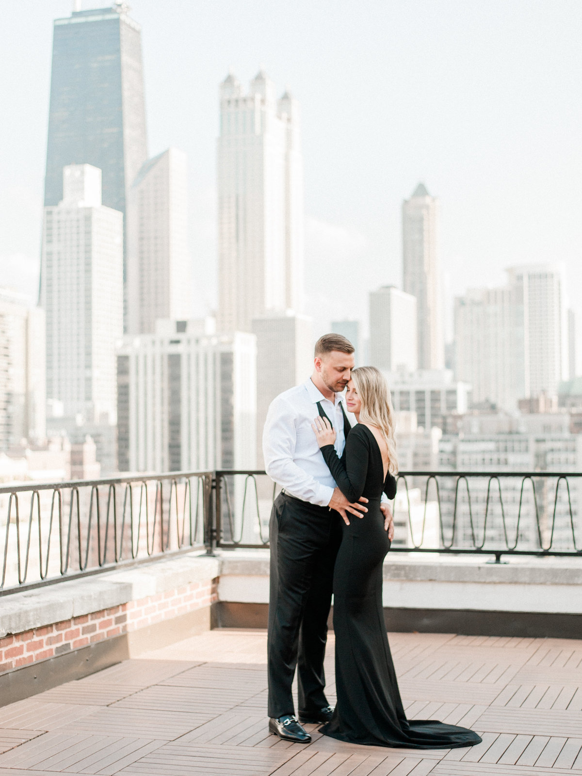 engaged couple hugging on chicago rooftop