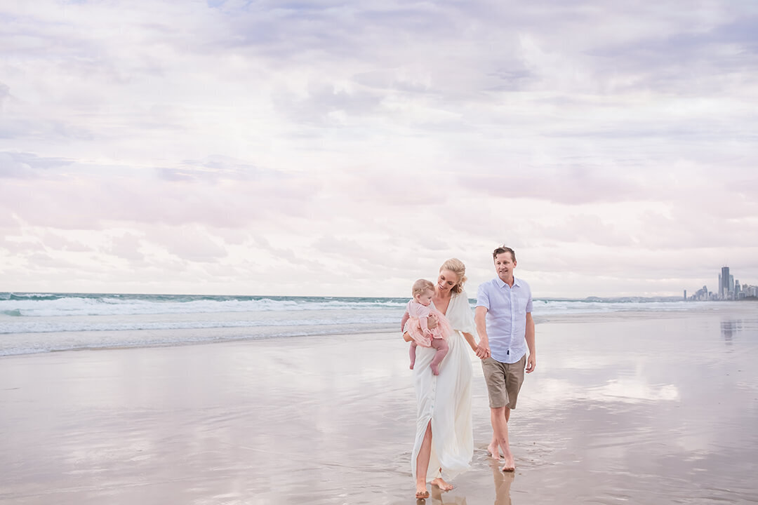 Brisbane family captures their happiness: Candid lifestyle portrait amidst the beach's natural beauty.