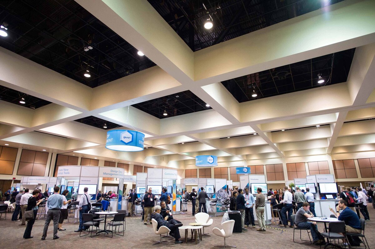 A large ballroom filled with people and booths at the 2012 ESRI Developer Summit Palm Springs
