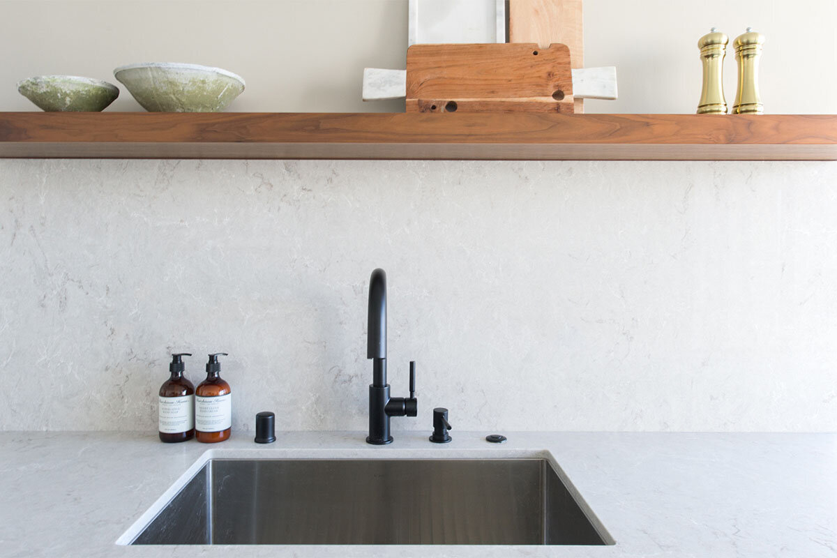 kitchen with floating shelf above sink