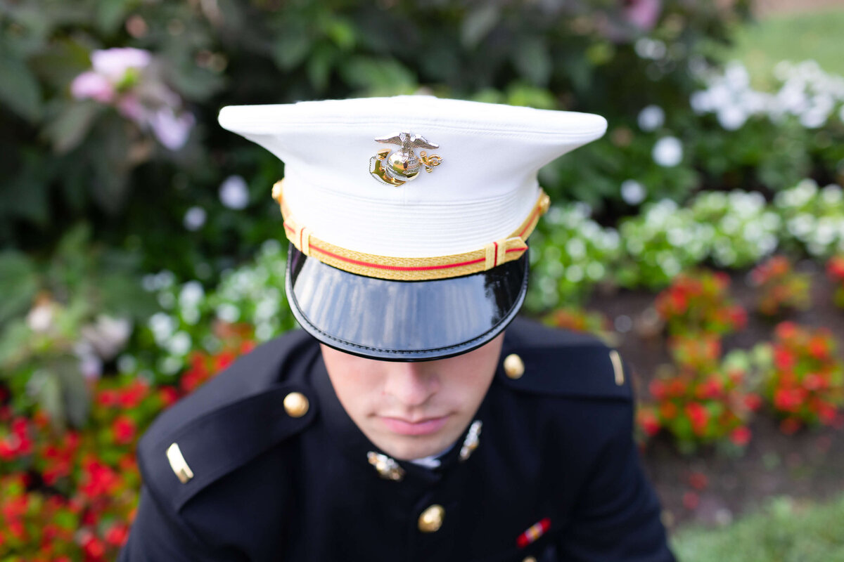 Midshipman Marine Cover and red flowers details during senior photography sessions with Kelly Eskelsen in Annapolis, Md.
