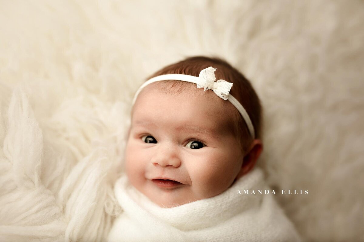 Close up portrait of newborn smiling into the camera