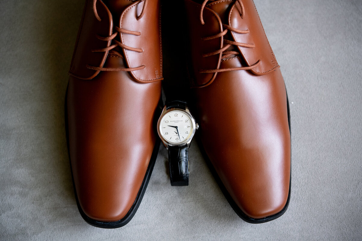 Still life of brown shoes and black watch New York wedding photographer Milestone Images